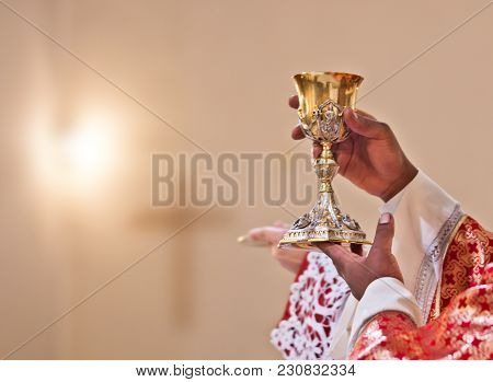 Hands Of The Priest Raise The Blood Of Christ