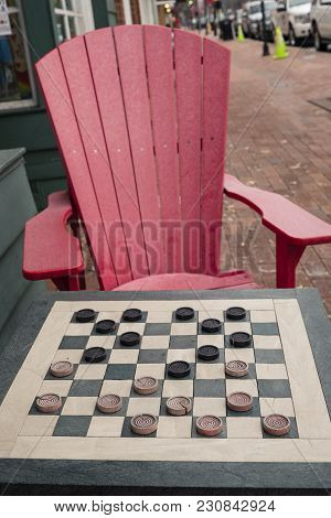 Checkers Game In Public On Sidewalk, Step Up And Take A Seat To Play The Game With A Friend Or Stran