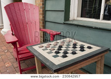 Checkers Game In Public On Sidewalk, Step Up And Take A Seat To Play The Game With A Friend Or Stran