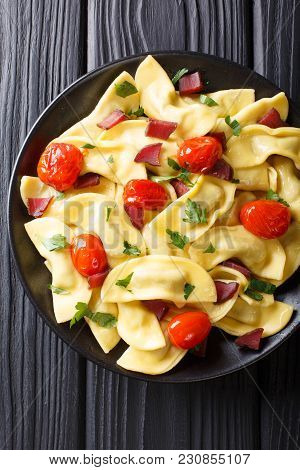 Homemade Dumplings Stuffed With Ham, Cherry Tomatoes And Fresh Herbs Close Up On A Plate On The Tabl