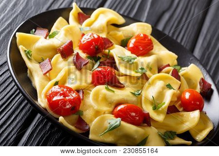 Delicious Dumplings Casoncelli With Ham, Cherry Tomatoes And Greens Close-up. Horizontal