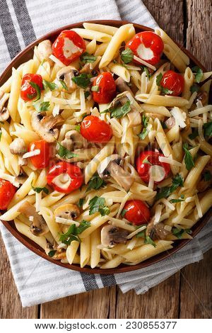 Italian Penne Pasta With Fried Mushrooms, Tomatoes, Pepper And Parmesan Close-up. Vertical Top View