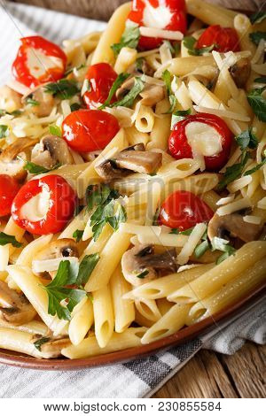 Penne Pasta With Fried Mushrooms, Tomatoes, Pepper And Cheese Close-up. Vertical