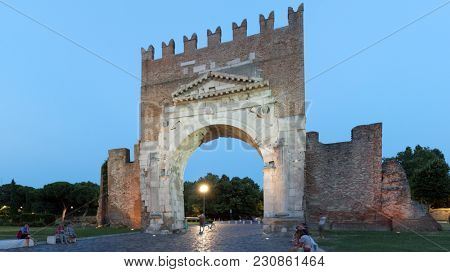 RIMINI, ITALY - JUNE 13, 2017: People resting at the Arch of Augustus. The arch was dedicated to the Emperor Augustus by the Roman Senate in 27 BC and is the oldest survived Roman arch