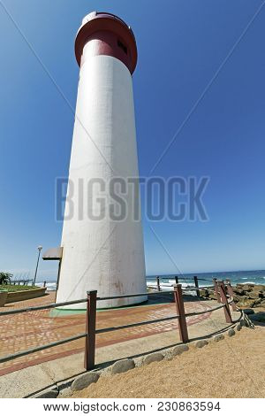 Portrait Red And White Lighthouse On Coastal Landscape