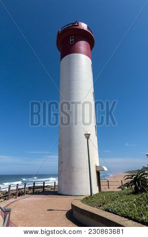 Portrait Red And White Lighthouse On Coastal Landscape