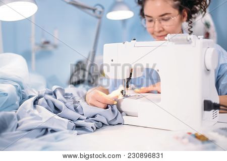 Cropped Shot Of Woman Learning To Sew On Sewing Machine In Design Studio. Attending Lessons Of Sewin