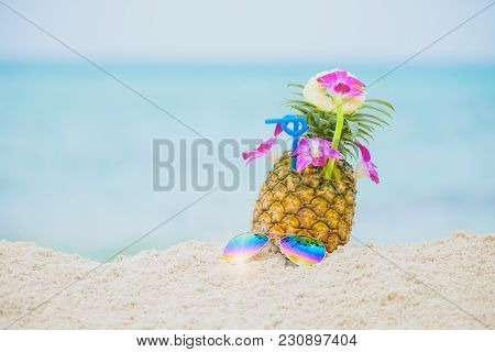 Purple Orchid Flower Put On Fresh Pineapple Juice And Sliced Pineapple Fruit With Sunglass On Beach 