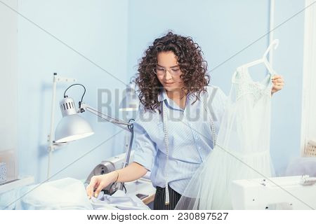 Beautiful Seamstress Making Out An Order Of Sewing Nightgown At Atelier. Sewing For People, Customer