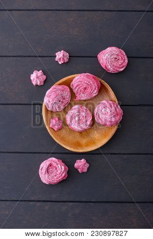 Sweet Meringues Cookies On Wooden Plate. On Dark Background