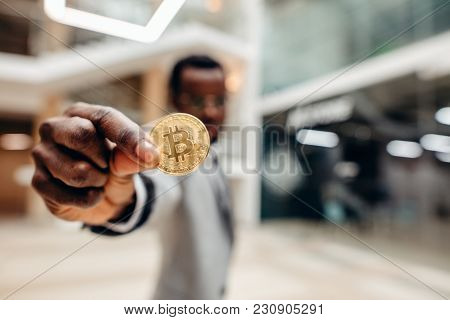 Golden Bitcoin In African Man Hand, Businessman Holding Digitall Symbol Of New Virtual Currency
