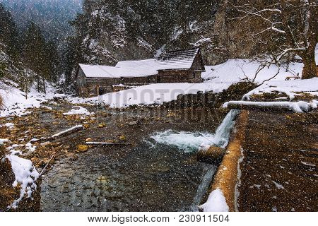 Old Wooden Water Mill At National Nature Reserve Kvacianska Dolina In Slovakia In Winter With Snow F