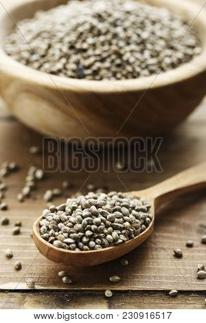 Cannabis Seeds In A Plate And Spoon On A Wooden Background, Space For Text