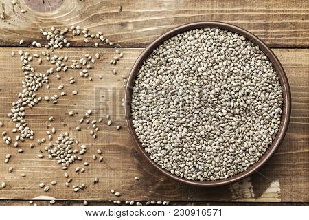 Cannabis Seeds In A Plate Close-up On A Wooden Background, Space For Text