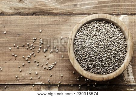 Cannabis Seeds In A Plate, On A Wooden Background, Space For Text