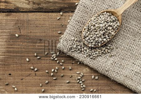 Hemp Seeds In A Rustic Wooden Spoon On The Burlap Napkin, Space For Text