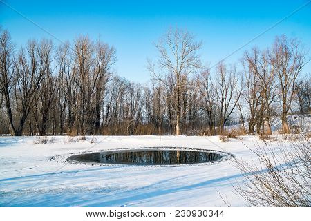 A Small Polynya On A Small Lake On A Sunny Day. Winter Landscape
