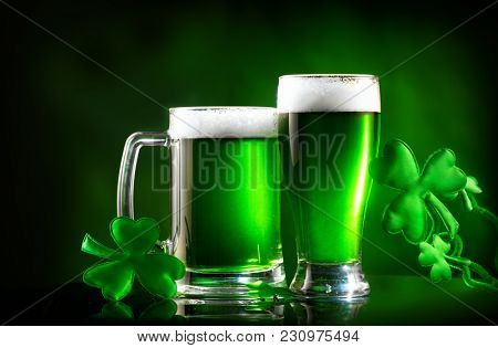 St. Patrick's Day Green Beer pint over dark green background, decorated with shamrock leaves. Patrick Day pub party, celebrating. Glass of Green beer close-up. Border art design, Wide format banner