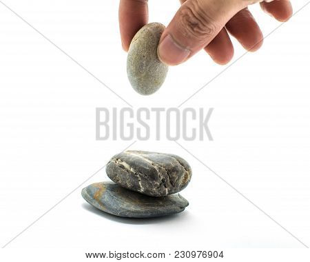 The Stones Are Stacked And The Hands Are Holding Stones Being Laid On A Pile Of Rocks On White Backg