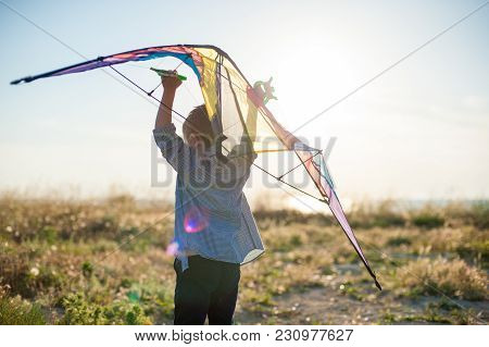 Dreamy Little Boy With Big Kite In His Hands Over His Head