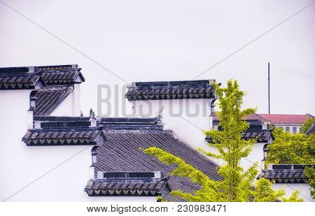 The Walls And Rooftops Of Various Buildings Within The Classical Chinese Li Yuan Garden In Zhaojialo