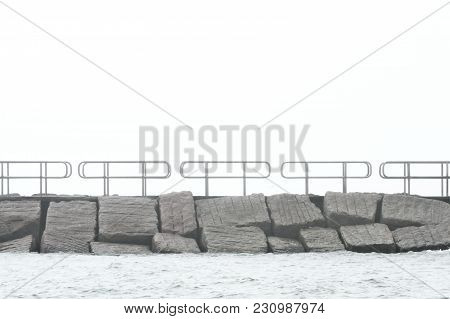 Jetty And Water On A Gray Foggy Day