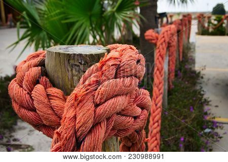 Orange Nautical Rope On Wood Poles As Partition