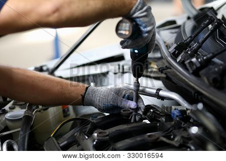 Close-up On Automechanic Hands Checking Automobile Parts. Machine Details Necessarily Used For Perfe