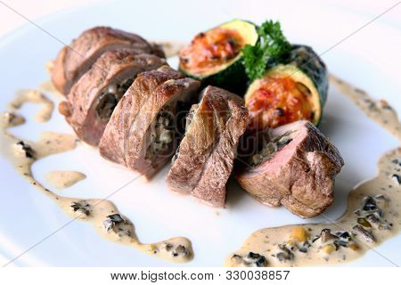 Beef Roll With Mushroom Filling. Slices Of Roll On A Plate With Sauce.