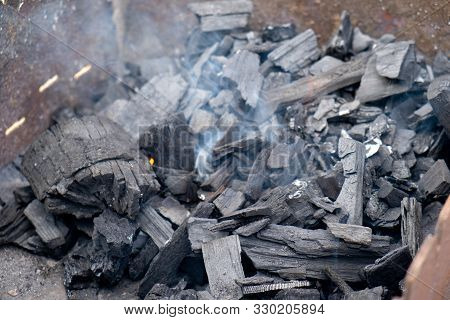 Charcoal Ignition On A Brazier. Light Smoke And Selective Focus.