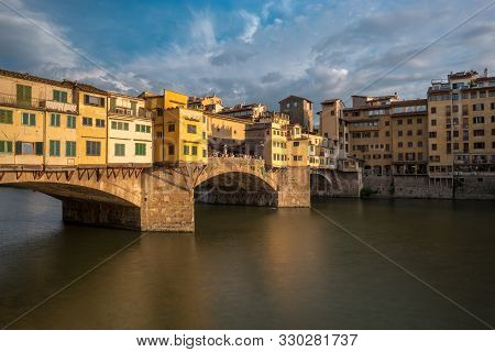 Side View Of Medieval Stone Bridge Ponte Vecchio Over The Arno River In Florence, Tuscany, Italy. Vi