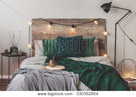 Yerba Matte On Wooden Plate On King Size Bed With Grey Bedding And Emerald Grey Blanket