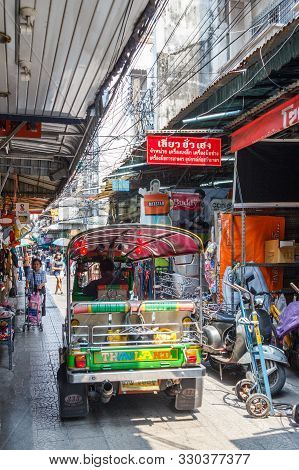 Bangkok, Thailand - 24th March 2018: A Tuk Tuk Makes Its Way Along The Narrow Sampeng Lane. The Lane