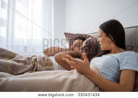 Young Couple Is Arguing In Bed. Man Can Not Listen Anymore.