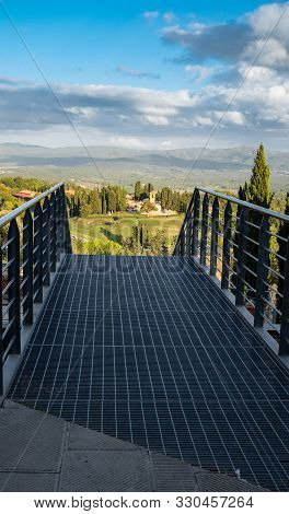 The View From The Top Of A Metal Walkway At Casole D'elsa Of The Tuscan Countryside, Bright Blue Sky