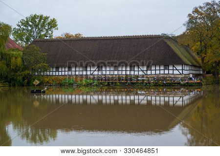 Egeskov Slot, Denmark, Europe: An Old Stable Building With Nice Reflection In A Pond Near Egeskov Ca
