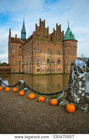Egeskov, Denmark, Halloween: Orange Pumpkins Decorate The Bridge Across The Lake. Beautiful Egeskov 
