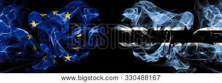 Eu, European Union Vs Botswana, Botswanan Smoke Flags Placed Side By Side. Thick Colored Silky Smoke