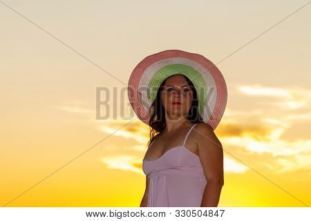 Jewish Woman In A Hat At Sunset On A Background Of The Sea.