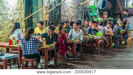 People Eating Street Food In Old Quarter Of Hanoi By Night