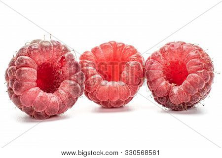 Group Of Three Whole Fresh Crimson Raspberry Isolated On White Background