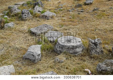 Fragments Of Ancient Buildings, The Ruins Of The Ancient City Of Hierapolis. Stone Blocks With Trace