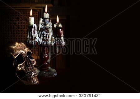 Old Battered Skull Lies With An Antique Wooden Candlestick