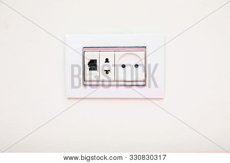 A Socket On A Light Gray Wall, A Multifunction Outlet With An Internet Connection . Electric Light S
