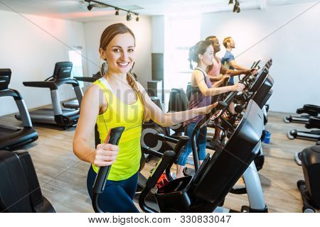 Caucasian woman and her friends doing step training in gym for better fitness
