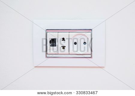 A Socket On A Light Gray Wall, A Multifunction Outlet With An Internet Connection . Electric Light S