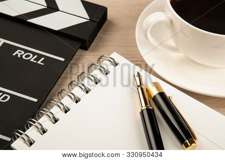Movie Clapper, Cup Of Coffee And Fountain Pen Diary Close Up