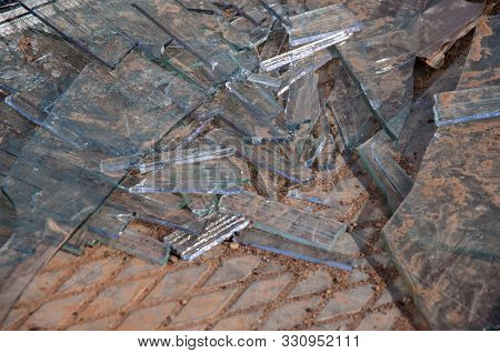 Shattered Glass On A Concrete Slab. Broken Glass. Broken Window.