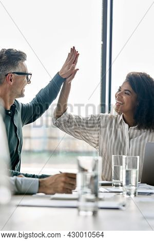 Two Happy Multiracial Professional Executive Businessman And Businesswoman Colleagues Giving Highfiv