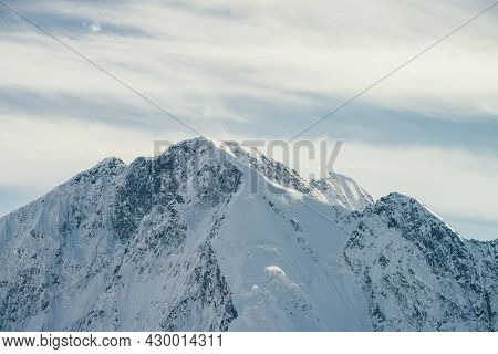 Great View To High Snowy Mountain Wall With Peaked Top Under Cirrus Clouds In Sky. Alpine Landscape 